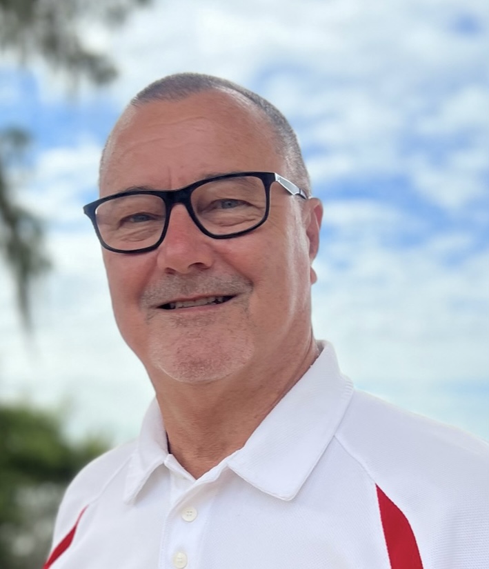A man with glasses and a white shirt